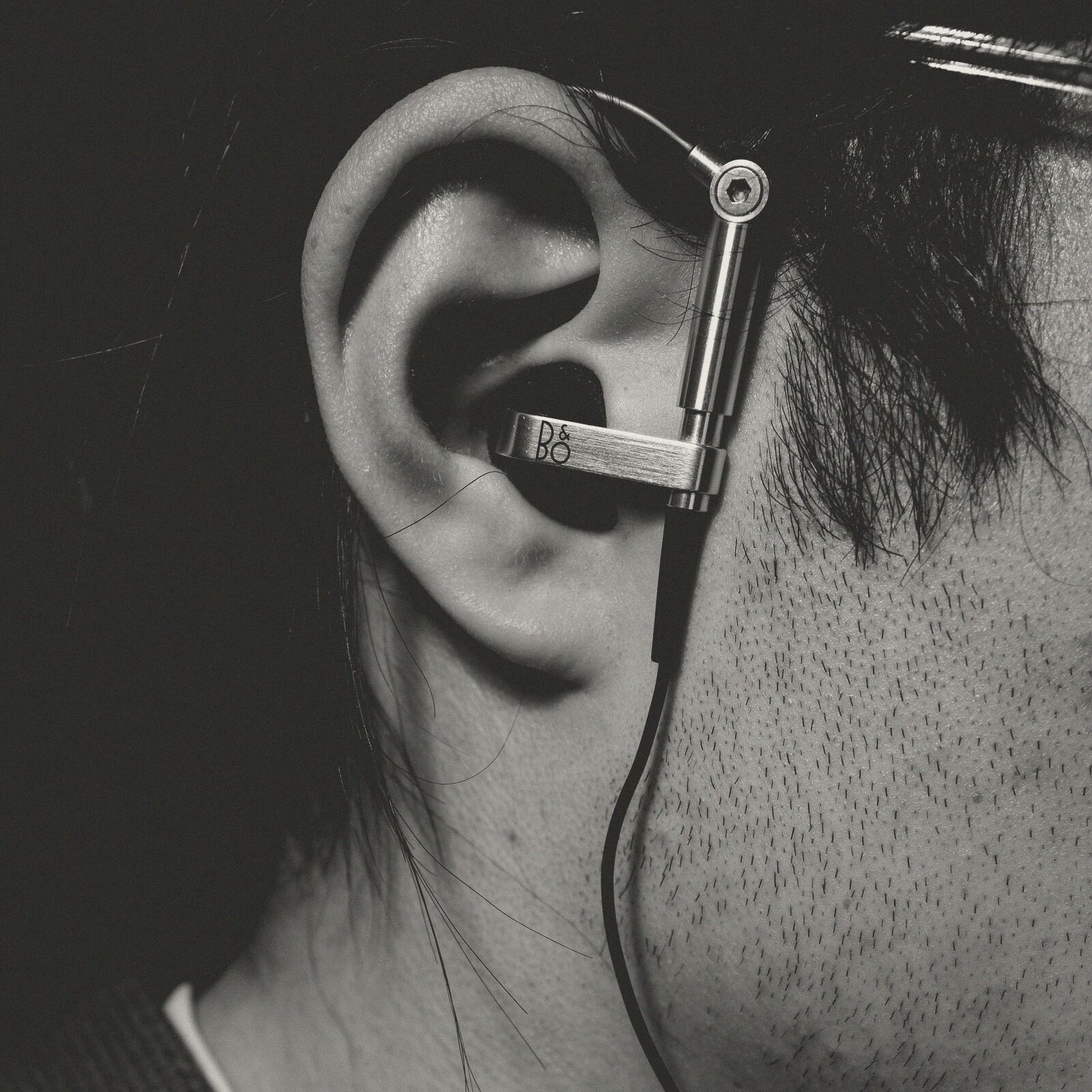 Close up of an ear with an earbud in it.